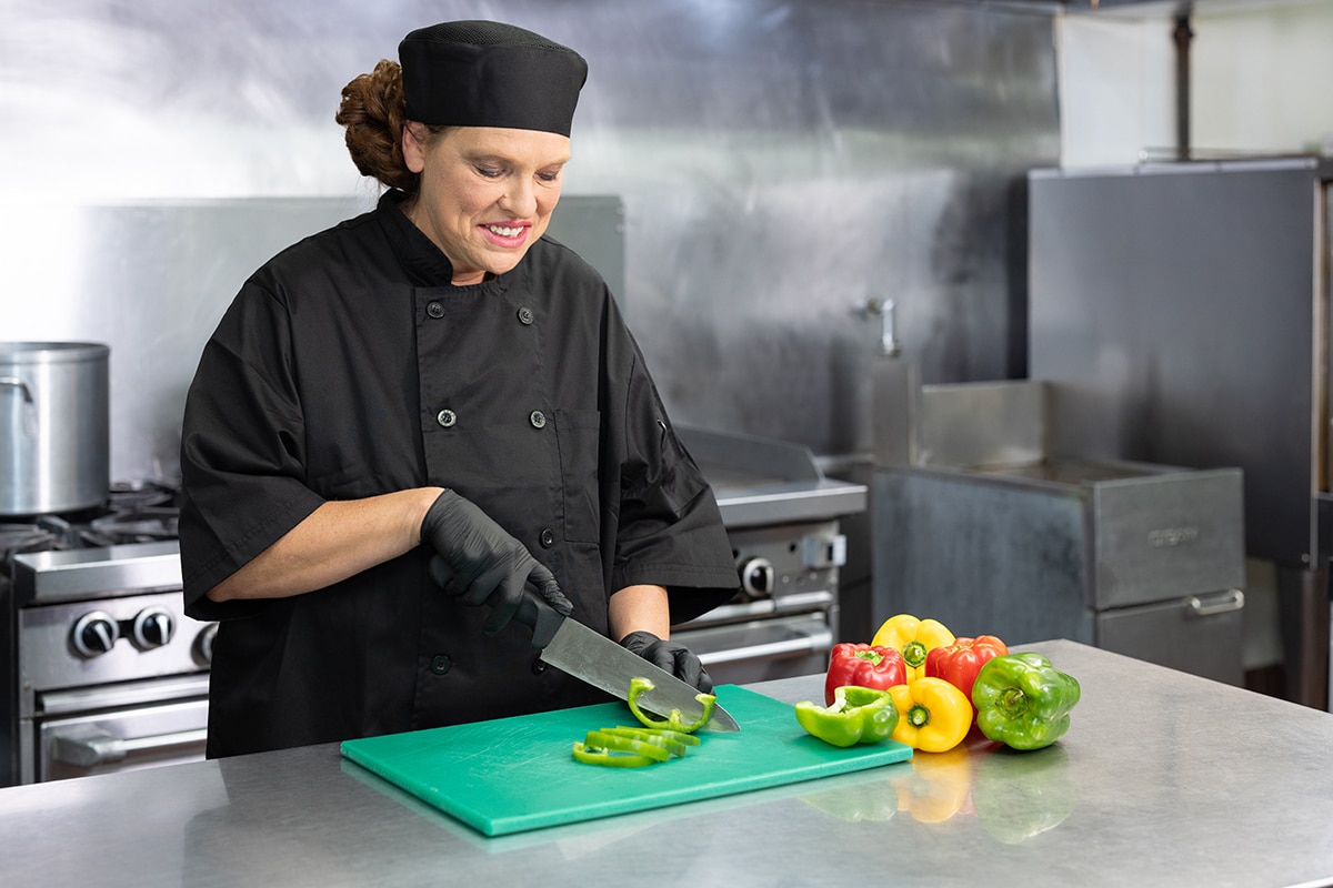 Chef slicing green bell pepper at Waverly Hills Post Acute