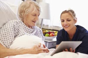 nurse working with female patient in bed